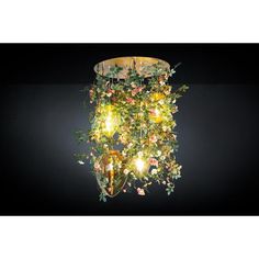 a chandelier with flowers hanging from it's sides on a black background