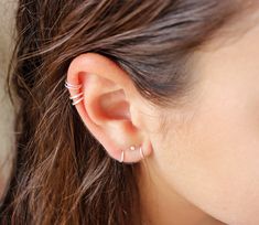 a close up of a person's ear with two piercings on the side