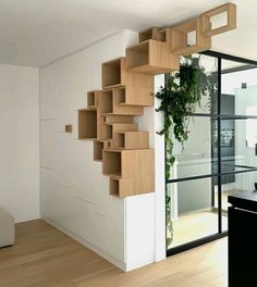 a room that has some shelves on the wall and plants growing out of it's sides