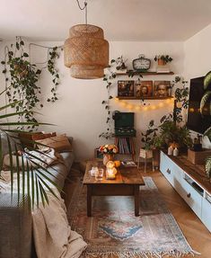 a living room filled with furniture and plants