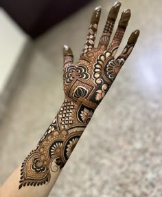 the hand is decorated with intricate designs on it