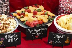 three different types of desserts on display at a party with signs that read, mickey mouse mix and chips'n dale