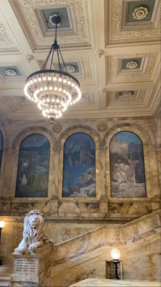 the interior of a building with paintings on the walls and ceiling, including a chandelier