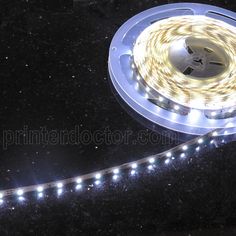 a close up of a light strip on a black surface with stars in the background