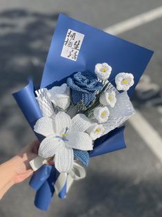 a person holding a bouquet of flowers in their hand