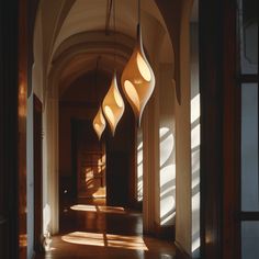 three lamps hanging from the ceiling in a hallway