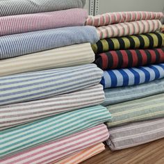 a stack of folded towels sitting on top of a wooden floor