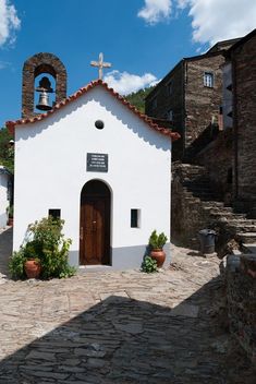 a small white church with a bell tower