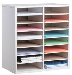 a white shelving unit filled with files and folders