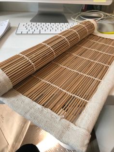 a computer desk with a bamboo mat on top of it and a keyboard next to it