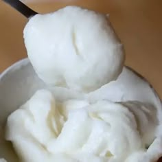 a spoon full of whipped cream in a bowl