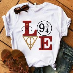 a t - shirt with the word love on it next to some shoes and sunglasses