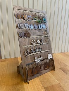 a wooden display with many different earrings on it