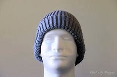 a white mannequin head wearing a gray knitted hat on top of it