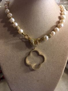 This pearl necklace is made of freshwater pearls, gold plated: beads, cz lobster claw clasp, cz quatrefoil pendant and findings. This necklace measures 34 inches in length and the pendant is 1 1/2 inches. This necklace can also be made in silver. The pictures do not do it justice. I have the necklace and so do several of my friends. We all get sooooo many compliments on it! All of our jewelry is unique and custom designed. Most of our jewelry can easily be resized. If there is a piece of jewelry Yellow Gold Beaded Pearl Necklace For Wedding, Elegant Bridal Necklace With Gold Beads And Pearls, Elegant Pearl Bridal Necklace With Gold Beads, Elegant Bridal Pearl Necklace With Gold Beads, Wedding Yellow Gold Beaded Pearl Necklace, Gold Akoya Pearl Beaded Necklace, Luxury Gold Beaded Necklaces For Wedding, Gold Pearl Beaded Necklaces For Anniversary, Exquisite Pearl Necklace With Pearl Charm