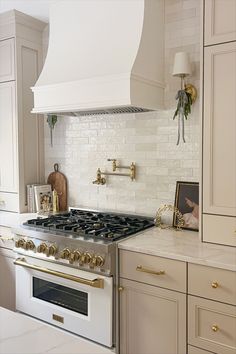 a white stove top oven sitting inside of a kitchen next to cabinets and counter tops