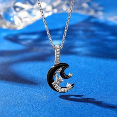 Shimmering with fascinating celestial style, this moon & star necklace draws all the right kinds of attention. Created in sterling silver, it showcases a black crescent moon adorned with glistening white stones, dots of stars, and a smaller silhouette of the moon. The fanciful design is completed with exquisite workmanship and dainty polishing details. This graceful necklace is reminiscent of the beautiful and arcane night sky. Make it a great gift for her on a special day!Carat Weight: 0.211 ct Black Crescent Necklaces As Gift, Black Moon Shaped Jewelry For Gift, Black Half Moon Jewelry For Gift, Black Moon Shaped Jewelry Gift, Black Crescent Necklaces For Gift, Black Moon Jewelry With Sun And Moon Design, Black Half Moon Jewelry With Moon Phase Design, Black Moon Phase Necklace For Gift, Black Half Moon Jewelry With Moon Phase Detail