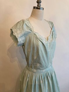 "Rare Clare Potter mint green embroidered floral cotton dress has scalloped sleeves, hem and neckline with a matching belt with a single covered button. Dress zips up in the back and is in excellent vintage condition. The bodice on the dress seems too have been made for someone with a long torso, so please mind the measurements listed below! Shoulders 17\" Chest 38-40\" Waist 28\" Hips 60\" Underarm seam to waist seam 9\" Length from top of shoulder to hem 45\" Vintage garments have been previou Elegant Cotton Dress With Scalloped Edges, Fitted Cotton Dress With Scalloped Edges, Cotton Dresses With Scalloped Edges And Short Sleeves, Vintage Green Dress With Floral Embroidery, 1950s Cotton Spring Dresses, 1950s Cotton Dresses For Spring, Spring Wedding Cotton Vintage Dress, Spring Wedding Vintage Cotton Dress, Scalloped Sleeves