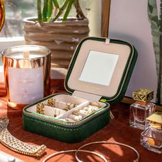 an advertisement for the water mission with jewelry and accessories on a table in front of a mirror