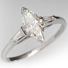 an oval and baguette cut diamond ring with tapers on the shoulders, set in white gold