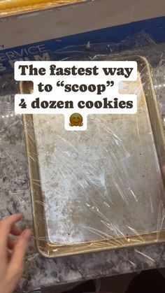 someone is holding up a cookie sheet with the words, the fastest way to scoop? 2 dozen cookies