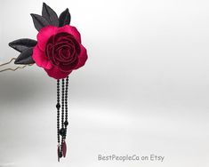 Beautiful handmade Hair Pin with Purple Rose.  Caution: Keep away from any kind of water or oil. The flower hairpin has long been a favorite decoration, carefully preserved since ancient times.  However, the flowers are fleeting, subject to seasonal restrictions and rapid decline. Thus, noblewomen of ancient times craved timeless floral accessories, which led to the creation of handmade Chanhua. Perfect gift for girls or women on Christmas party, special holidays, wedding parties, graduation, birthday,  etc. The flower size is  2 inch. With leaves is about 3.75 inch The weight is 20 grams Thank you. Handmade Hairpin, Black Leaves, Flower Ornaments, Flower Hair Pin, Floral Accessories, Purple Roses, Holiday Specials, Silk Flowers, Gifts For Girls