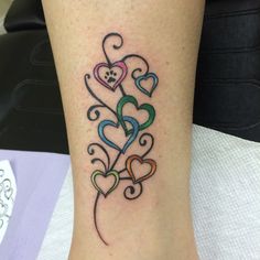 a woman's stomach with the word love and hearts tattooed on her back shoulder