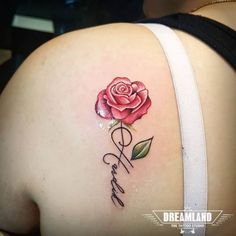 a woman's back with a rose tattoo on her left shoulder and the word faith written in cursive writing