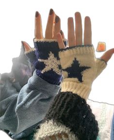 two hands wearing mittens and gloves with stars on them