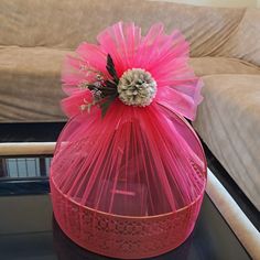 a pink vase sitting on top of a table