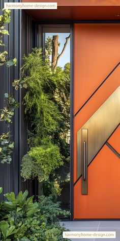 an orange front door with metal accents and trees in the backround behind it