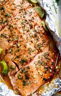 salmon in foil with vegetables and seasoning on top