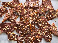 pieces of chocolate and nuts on a baking sheet