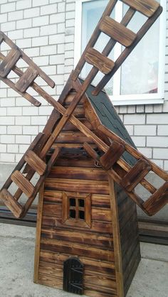 a house made out of wooden boards and ladders