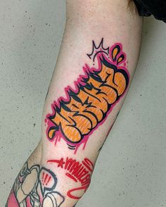 a man's arm with graffiti on it