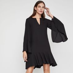 This Flowing Shift Dress In Satin-Back Crepe Features Long Flutter Sleeves, A Split V-Neckline, And A Flounced Hem. Pullover Fabric Self: 100% Polyester Satin-Back Crepe Machine Wash Imported A Size Small Measures Approximately 36.25" From Shoulder To Hem Midweight, Non-Stretch Fabric Above-The-Knee Hemline Easy Fit Model Is Approximately 5'9” (175cm) And Is Wearing An Xs Bcbg Small Is A Size 6 Evening Flowy Mini Dress With Ruffle Hem, Flowy Mini Dress With Ruffle Hem For Evening, Elegant Black V-neck Ruffle Dress, Elegant Black Mini Dress With Ruffle Sleeves, Elegant Bell Sleeve Mini Dress For Brunch, Chic Black Mini Dress With Flutter Sleeves, Chic Flutter Sleeve Mini Dress For Work, Elegant Flowy Ruffle Dress With Flutter Sleeves, Elegant Flowy Ruffle Dress For Fall