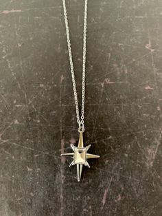 "Lovely silver tone 8 point star necklace with center emerald cut clear stone, star necklace, star necklace silver, 8 point star pendant, clear stone necklace, north star necklace, star  Pendant measures 1\" L X 7/8\" W and is on an 18\" chain.   ★ Want to see more?  Please visit my shop at: https://www.etsy.com/shop/DesignsByPeg" Silver Star Of David Charm Jewelry, Silver Star-shaped Celestial Charm Necklaces, Silver Star Charm Necklace In Celestial Style, Silver Star Charm Necklaces In Celestial Style, Dainty Silver Starburst Jewelry, Silver Celestial Charm Necklace With Star Charm, Silver Star Charm Necklace, Silver Star Charm Necklaces, Silver Necklaces With Star Charm