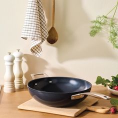 a frying pan sitting on top of a wooden cutting board