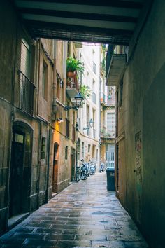 an alley way with motorcycles parked on both sides