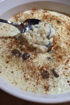 a white bowl filled with oatmeal sitting on top of a wooden table