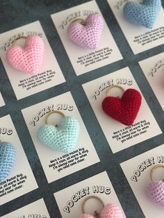 crocheted heart shaped keychains are displayed on cards