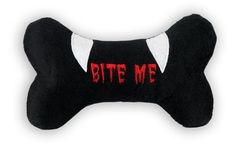 a black dog bone with the word bite me on it's side and red lettering that says bite me