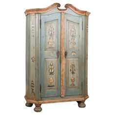 an old painted armoire with flowers on it