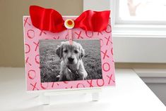 a photo frame with a red bow on it