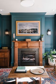 a living room with blue walls and a fire place in the center, along with a painting on the wall