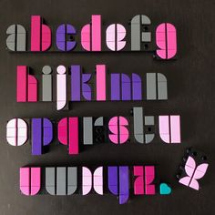 the letters are made out of paper and have butterflies on each letter's side