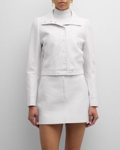 Courreges textured vinyl jacket featuring contrast logo patch chest    Part of the Iconic vinyl collection    Approx. 19"L from shoulder to hem; 25.2" sleeve length    Spread collar; snap front    Long sleeves    Side slip pockets    Straight fit    Cropped length    Cotton    Cupro, lining    Imported Fitted Luxury Outerwear With Snap Buttons, Luxury Fitted Outerwear With Snap Buttons, Designer White Outerwear With Buttons, Modern Outerwear With Snap Buttons, Modern Fitted Outerwear With Buttons, Luxury Spring Outerwear With Button Cuffs, Fitted Cropped Jacket With Snap Buttons And Long Sleeves, Fitted Cropped Jacket With Snap Buttons, Long Sleeve, Fitted Long Sleeve Cropped Jacket With Snap Buttons