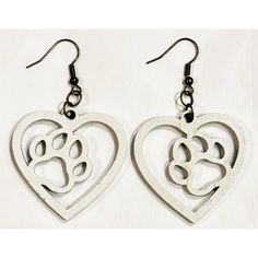 two heart shaped earrings with dog paw prints in the shape of hearts on white background