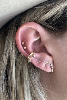 a close up of a person wearing ear piercings