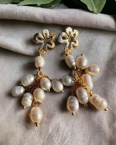 Zamak and gilded brass earrings with baroque pearls Gold Chandelier Earrings With Pearl Charm For Party, Handmade Yellow Gold Pearl Earrings, Handmade Baroque Pearl Earrings For Party, Gold Pearl Charm Clip-on Earrings, Gold Clip-on Pearl Earrings With Pearl Charm, Gold Clip-on Earrings With Pearl Charm, Gold Clip-on Pearl Earrings, Handmade Baroque Pearl Earrings In Pearl White, Handmade Baroque Pearl White Earrings